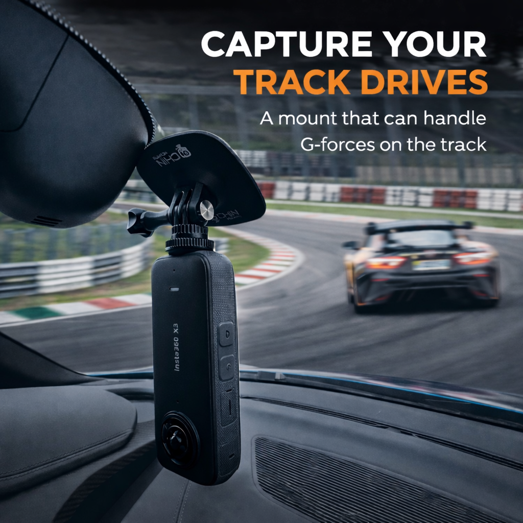 Car dashboard with a mount for a camera, racing track in the background