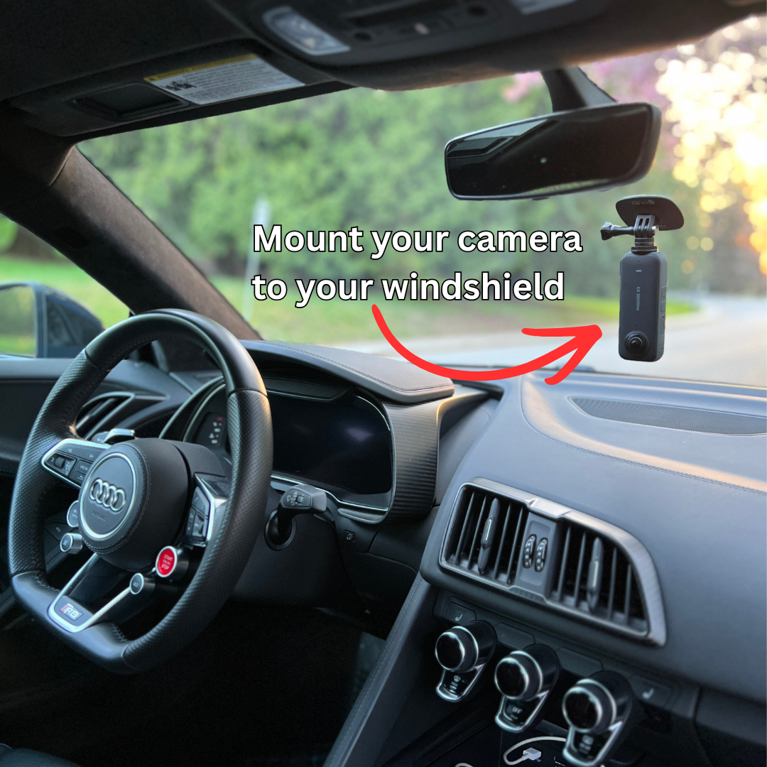 Car interior with a camera mounted on the windshield, indicating where to mount it.